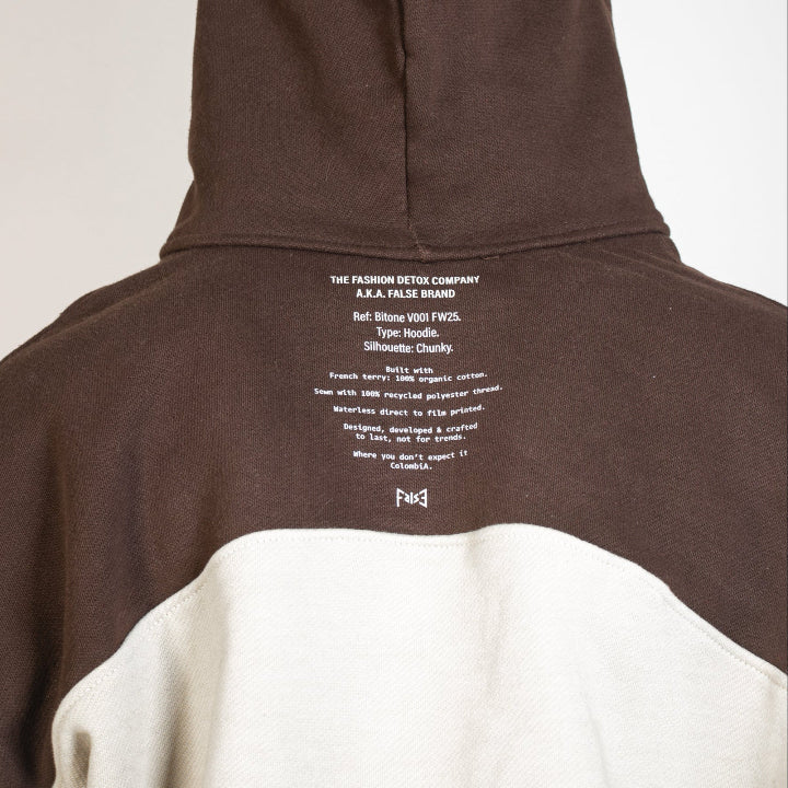 Brown and beige hoodie with text on the back against a white background