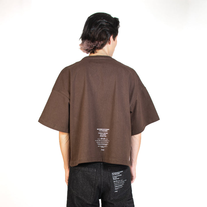 Person wearing a brown t-shirt and black pants on a white background
